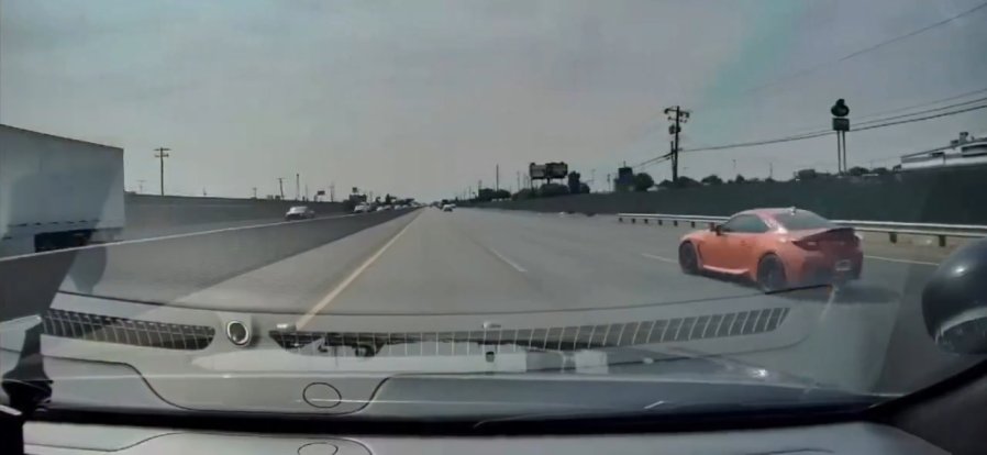 Driver zooms past cop in bright orange sports car